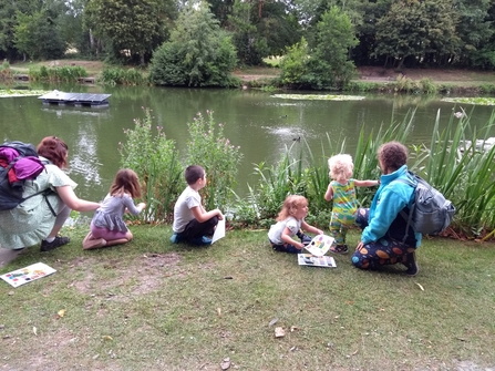 Families sat next to Lliswerry pond collecting flowers