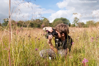 photographer in meadow