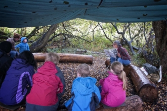 Reading to children at Forest school