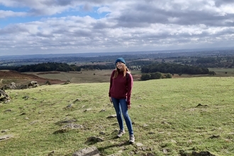 A young woman standing on a hillside