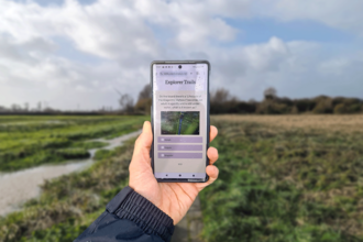 A phone screen web app with a nature reserve background