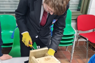 Aidan making a nest box