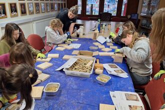 Children making bee hotels