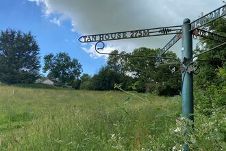 green field with blue sky at shirenewton meadows. 