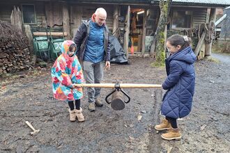 2 children carrying timber with special tongs