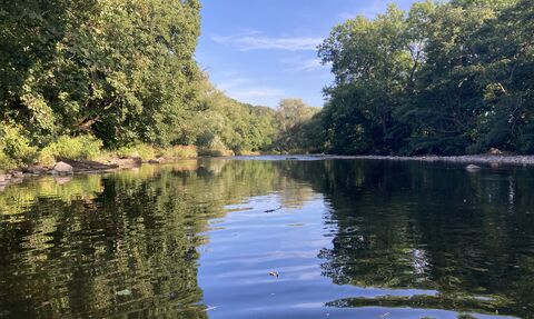 image of the river usk surrounded by trees on a blue sky sunny day