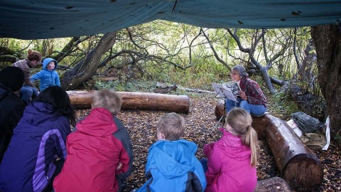 Reading to children at Forest school