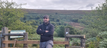 A picture of Connor Green standing next to the nature reserve