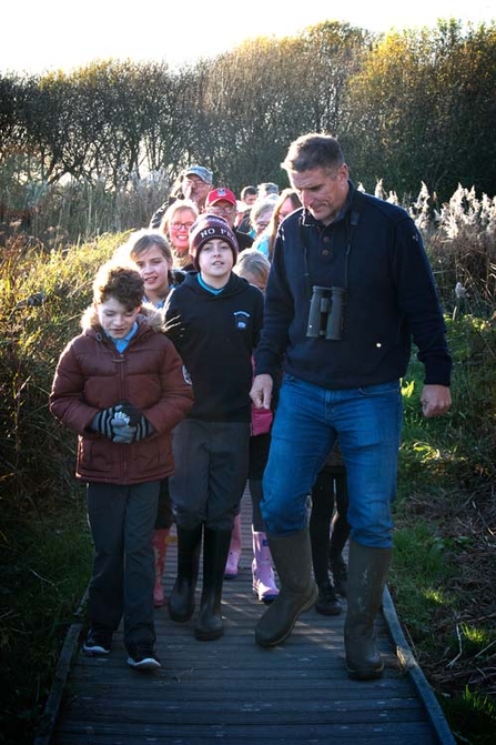 Iolo Williams with children from Magor school showing them around Magor Marsh