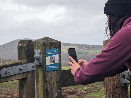 A Kath Beasley scanning a well placed sign