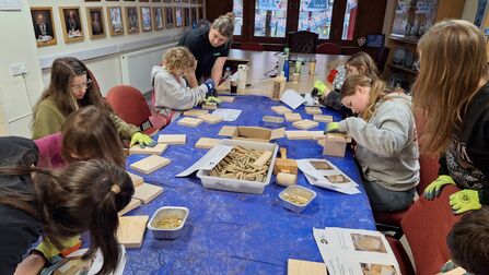 Children making bee hotels