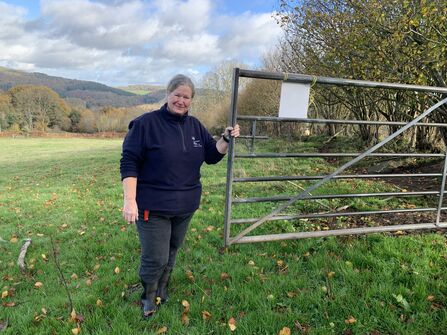 Volunteer Shepherd Pauline at field gate at Wyeswood Common