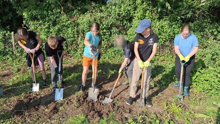 6 young people digging with spades
