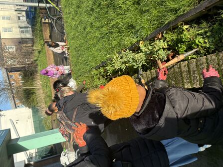 group of people tending to a garden